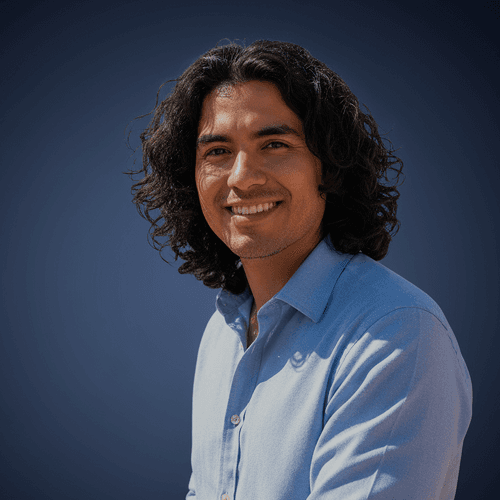 Man with long dark hair in a blue shirt