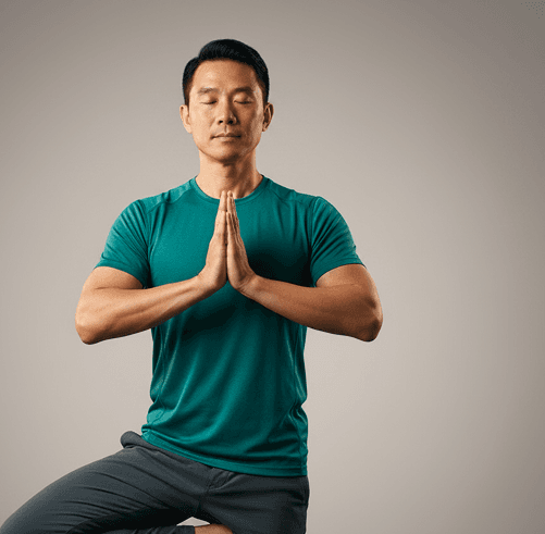 Man in a teal shirt with hands pressed together